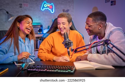 Young happy multiracial people performing at radio program making podcast recording for online show - Powered by Shutterstock