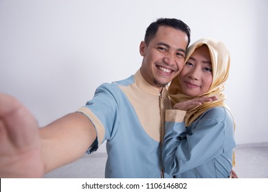 young happy muslim couple taking selfie with phone together - Shutterstock ID 1106146802