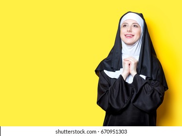 Young Happy Nun On Yellow Background