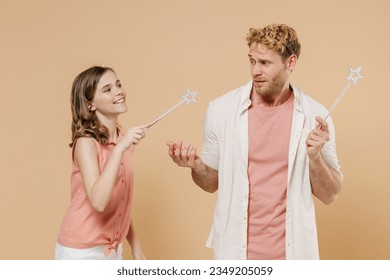 Young happy parent man with child teen girl wear casual clothes Daddy kid daughter hold princess magic wand feia stick playing isolated on beige background studio. Father's Day birthday family concept - Powered by Shutterstock