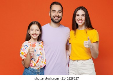 Young Happy Parents Mom Dad With Child Kid Daughter Teen Girl In Basic T-shirts Showing Thumb Up Like Gesture Isolated On Yellow Background Studio Portrait. Family Day Parenthood Childhood Concept.