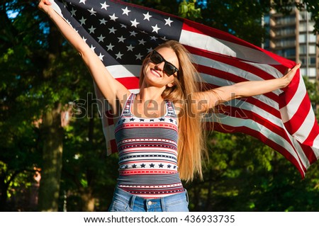 Young happy patriot girl holding the american, united states flag