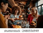 Young happy people having lunch together