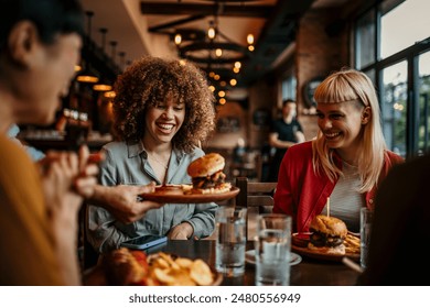 Young happy people having lunch together