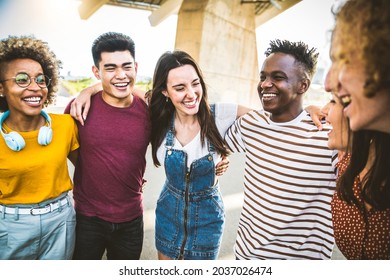 Young happy people laughing together - Multiracial friends group having fun on city street - Diverse culture students portrait celebrating outside - Friendship, community, youth, university concept