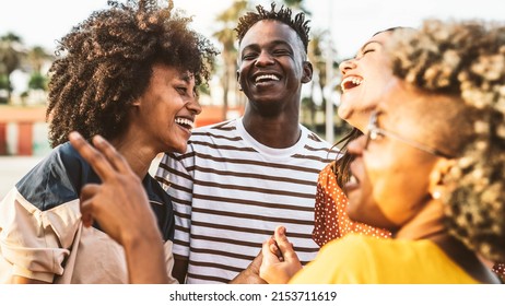 Young happy people laughing together - Multiracial friends group having fun on city street - Diverse culture students portrait celebrating outside - Friendship, community, youth, university concept.	 - Shutterstock ID 2153711619