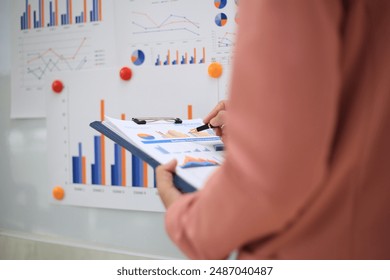 Young happy professional business woman employee sitting at desk working on laptop in modern corporate office interior. Smiling female worker using computer technology typing browsing web.