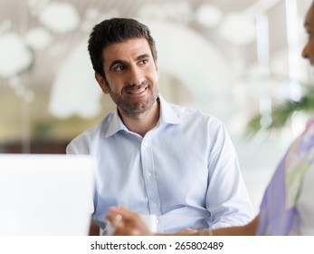 Young happy professional in office - Shutterstock ID 265802489
