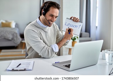 Young Happy Professor Using Computer And Teaching His Students Online From Home.