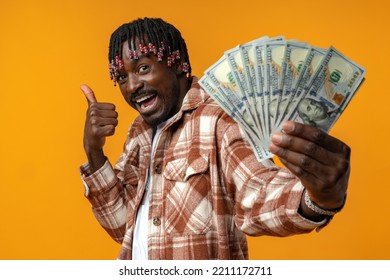 Young Happy Rich African Man In Casual Shirt Holding Dollar Bills Against Yellow Background