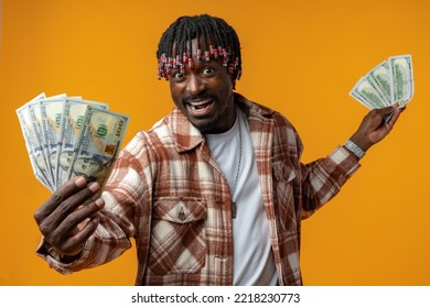 Young Happy Rich African Man In Casual Shirt Holding Dollar Bills Against Yellow Background