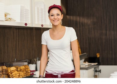 Young Happy Saleswoman Portrait Inside Ice Cream Shop. 