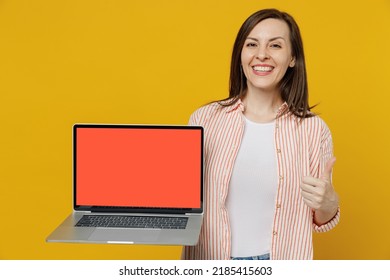 Young Happy Secretary Copywriter Woman She 30s In Striped Shirt White T-shirt Hold Use Work On Laptop Pc Computer With Blank Screen Workspace Area Show Thumb Up Isolated On Plain Yellow Background.