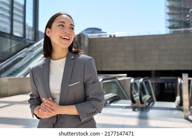 Young happy smiling beautiful Asian business woman, successful entrepreneur wearing suit standing in subway looking at ads copy space urban big city location outdoors. - Shutterstock ID 2177147471