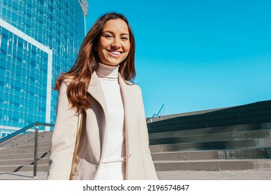 Young Happy Smiling Businesswoman Walking At City Stairs At Barcelona City Street To Office, Skyscrapers Cityscape Background. Copy Space.
