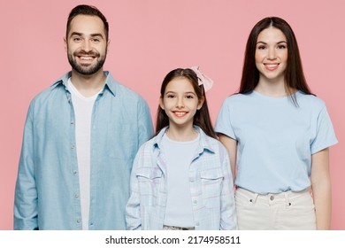 Young Happy Smiling Cool Parents Mom Dad With Child Kid Daughter Teen Girl In Blue Casual Clothes Look Camera Isolated On Plain Pastel Light Pink Background. Family Day Parenthood Childhood Concept