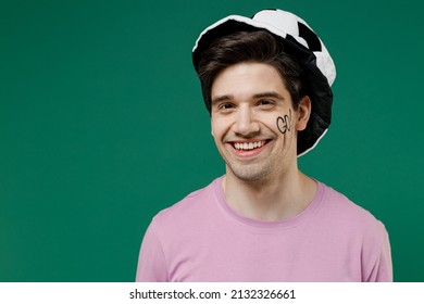 Young Happy Smiling Fun Man Fan Wear Basic Pink T-shirt Hat Go Text On Cheek Cheer Up Support Football Sport Team Watch Tv Live Stream Scream Look Camera Isolated On Dark Green Color Background Studio