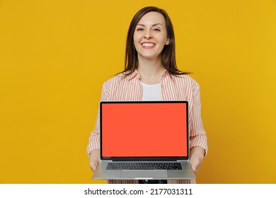 Young Happy Smiling Secretary Copywriter Woman She 30s In Striped Shirt White T-shirt Hold Use Work On Laptop Pc Computer With Blank Screen Workspace Area Isolated On Plain Yellow Background Studio.