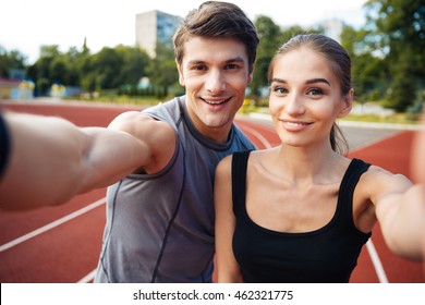 Young Happy Sports Couple Making Selfie Photo On Stadium