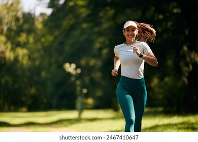 Young happy sportswoman jogging while exercising in nature, Copy space.  - Powered by Shutterstock