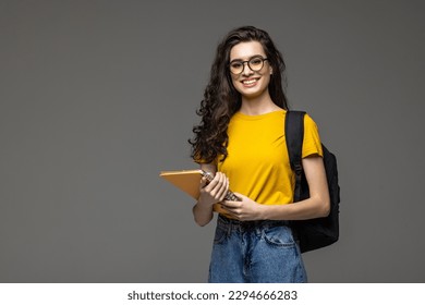 Young happy student with backpack on white
