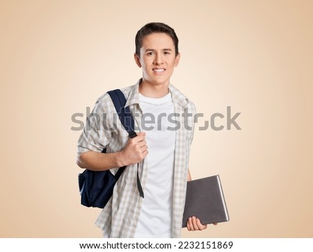 Young happy student posing with backpack