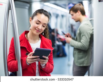 Young Happy Subway Passengers Busy With Modern Phones And Tablet 