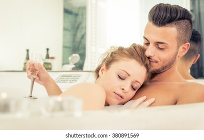 Young happy successful couple enjoying an hot bath in the jacuzzi