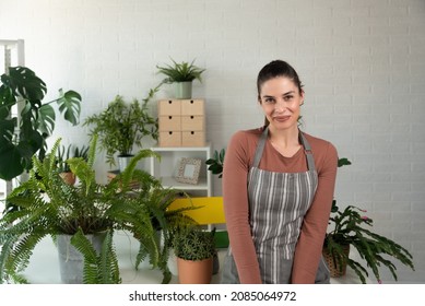 Young Happy Successful Woman Florist In Her Flowershop Surrounded With Flowers In Flowerpots Working Job She Love As Small Business Owner.