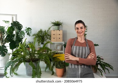 Young Happy Successful Woman Florist In Her Flowershop Surrounded With Flowers In Flowerpots Working Job She Love As Small Business Owner.