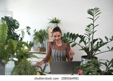 Young Happy Successful Woman Florist In Her Flowershop Surrounded With Flowers In Flowerpots Working Job She Love As Small Business Owner.