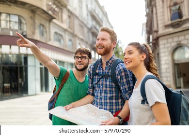 Young Happy Tourists Holding Map Sightseeing In City