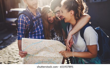 Young happy tourists sightseeing in city - Shutterstock ID 651937891