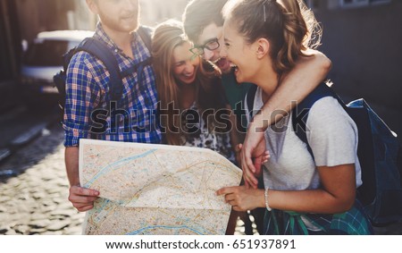 Young happy tourists sightseeing in city