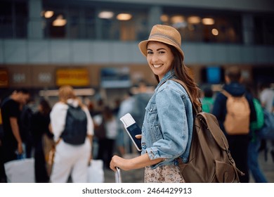 Young happy woman at the airport looking at camera. - Powered by Shutterstock