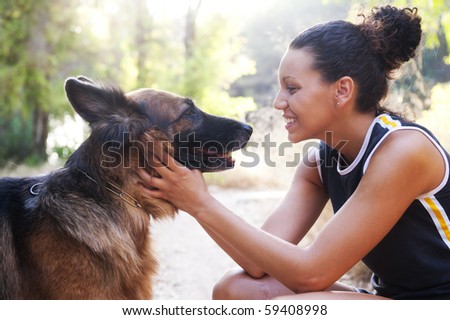 Young happy woman with is Belgian Malinois dog.