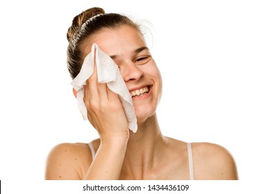 Young Happy Woman Cleaning Her Face With Wet Wipe On White Background