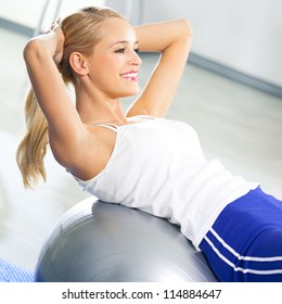 Young Happy Woman Doing Fitness Exercises With Fit Ball At Home