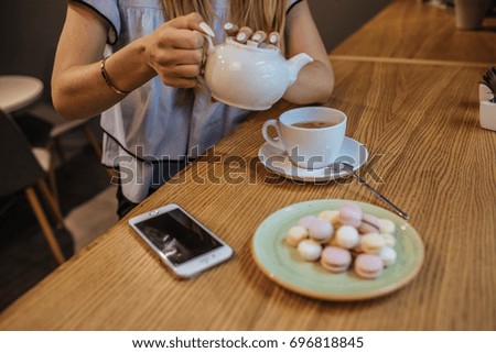 Young Happy Woman Drinking Green Tea in  a cafe