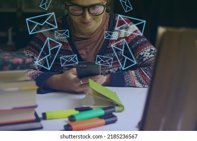 Young Happy Woman In Glasses Study At Night. Millennial Student Scrolling Phone. Blurred Books And Markers On Foreground. Education And Learning Concept. Online.