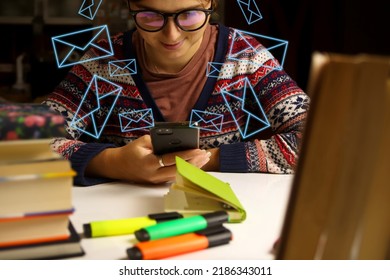 Young Happy Woman In Glasses Study At Night. Millennial Student Scrolling Phone. Blurred Books And Markers On Foreground. Education And Learning Concept. Online.