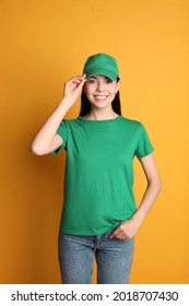 Young Happy Woman In Green Cap And Tshirt On Yellow Background. Mockup For Design