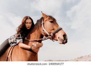 Young happy woman in hat with her horse in evening sunset light. Outdoor photography with fashion model girl. Lifestyle mood. Concept of outdoor riding, sports and recreation. - Powered by Shutterstock