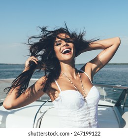 Young Happy Woman Have Fun On The Luxury Boat In Open Sea In Summer. Caucasian Female Model 