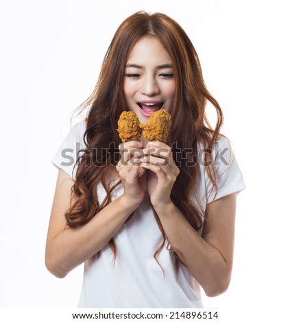 Young happy woman  holding and eating fries chicken on white background