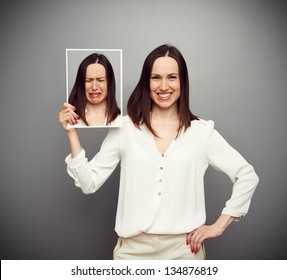 Young Happy Woman Holding Her Sad Picture