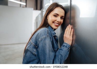 Young Happy Woman Leaning On Her New Refrigerator In A Mall