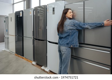 Young Happy Woman Leaning On Her New Refrigerator In A Mall