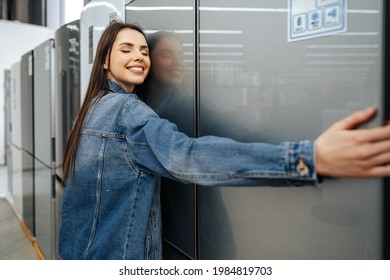 Young Happy Woman Leaning On Her New Refrigerator In A Mall