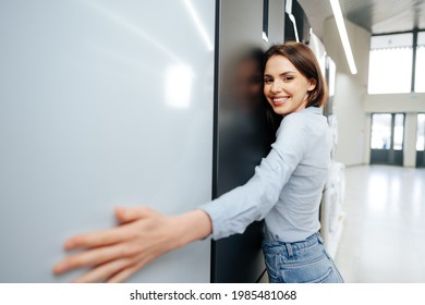 Young Happy Woman Leaning On Her New Refrigerator In A Mall